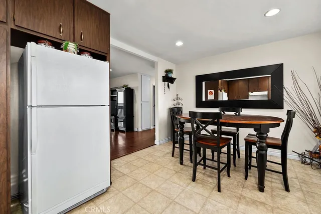 a dining room with a wooden table and chairs