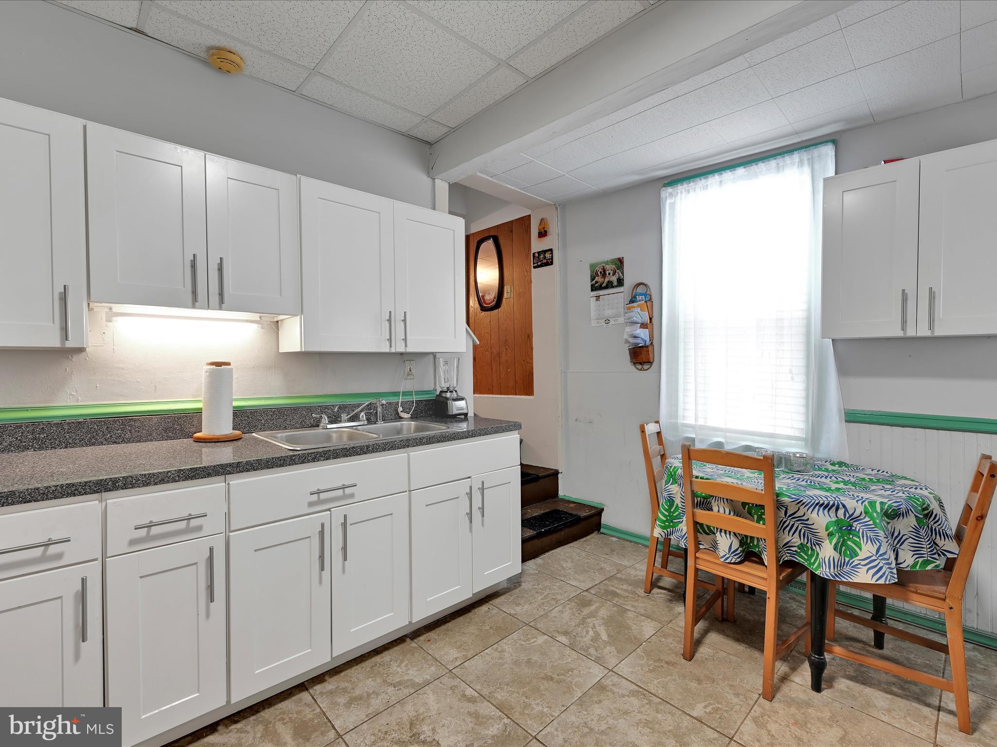 337 South 9th Street Lebanon, PA 17042 - Photo 12 of 26 a kitchen with granite countertop chair and white cabinets