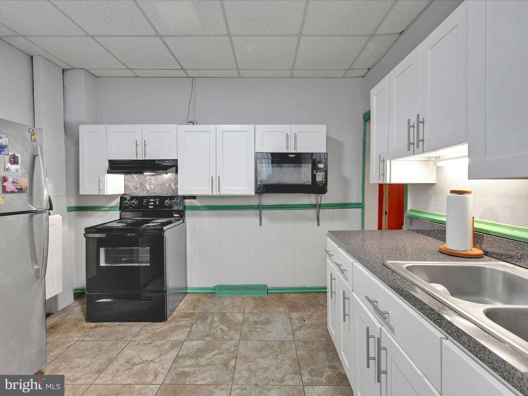 337 South 9th Street Lebanon, PA 17042 - Photo 14 of 26 a kitchen with stainless steel appliances granite countertop a sink stove and refrigerator