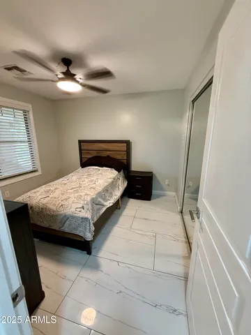 a bathroom with a granite countertop sink a toilet a mirror and shower