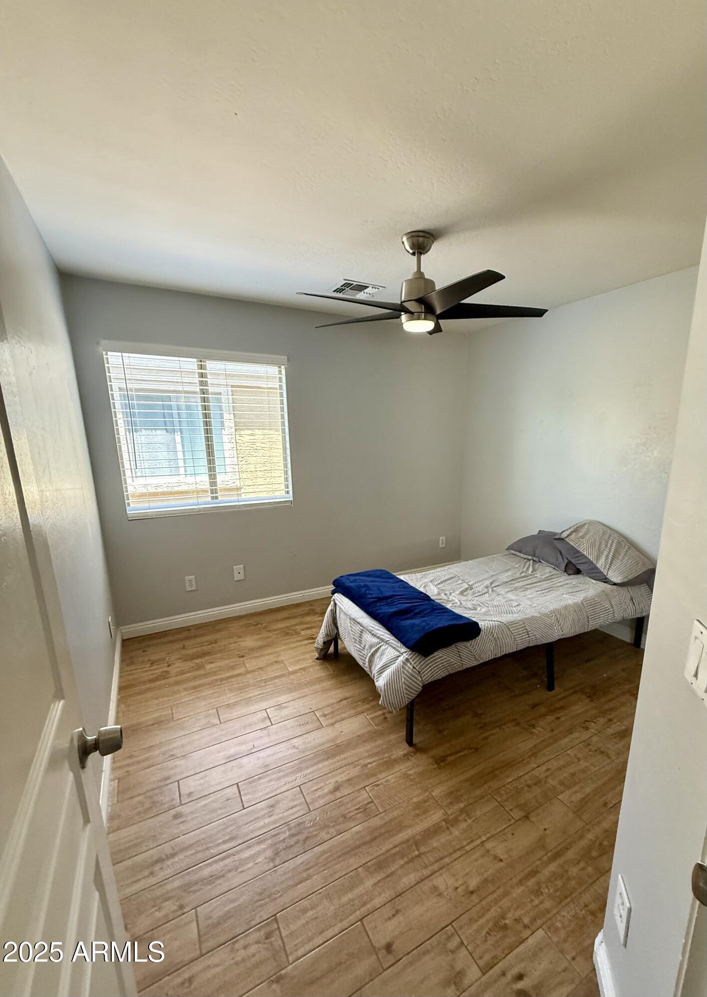 8534 West Cordes Road Tolleson, AZ 85353 - Photo 17 of 22 a view of a room with wooden floor and window