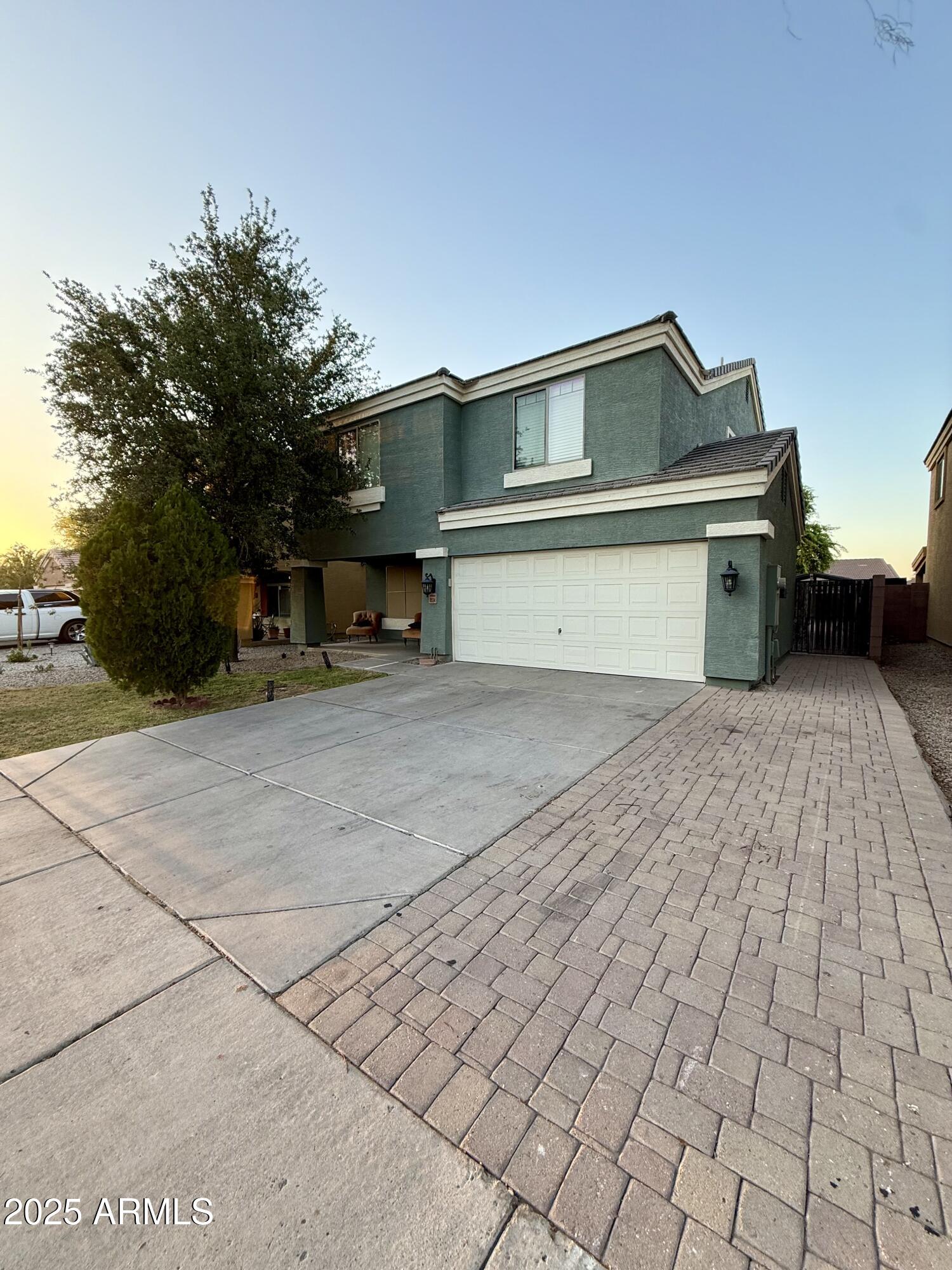 8534 West Cordes Road Tolleson, AZ 85353 - Photo 2 of 22 a front view of a house with a yard and garage