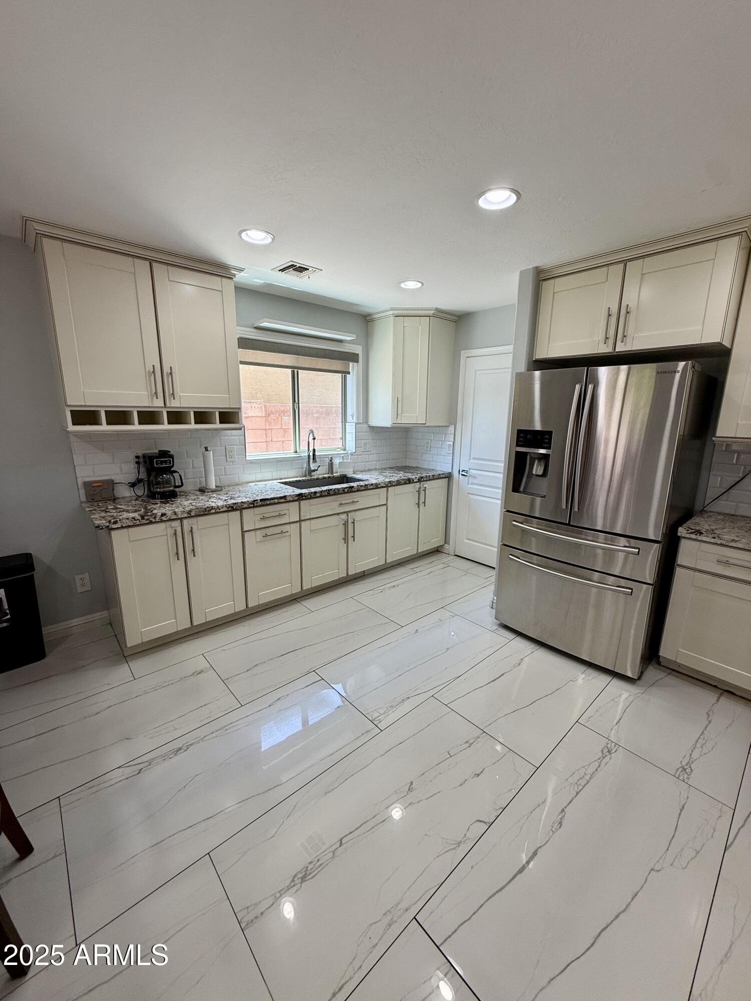 8534 West Cordes Road Tolleson, AZ 85353 - Photo 6 of 22 a kitchen with stainless steel appliances granite countertop a refrigerator sink and stove