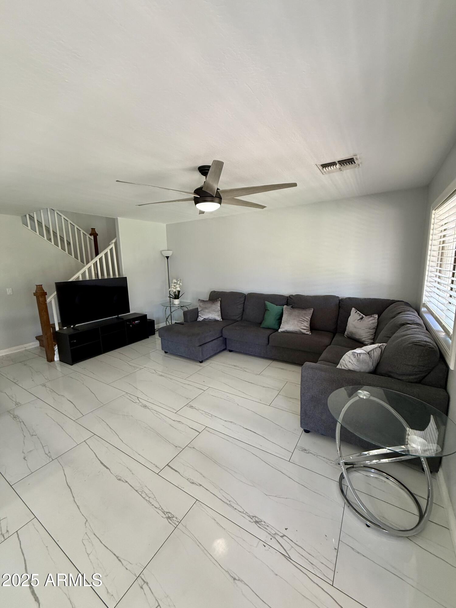 8534 West Cordes Road Tolleson, AZ 85353 - Photo 9 of 22 a living room with furniture and a air conditioner vent