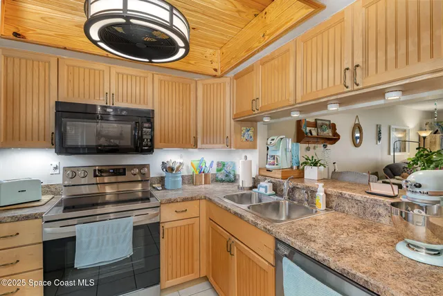 a kitchen with a stove a microwave and wooden cabinets