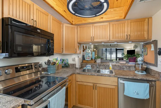 a kitchen with stainless steel appliances a stove a sink and a microwave