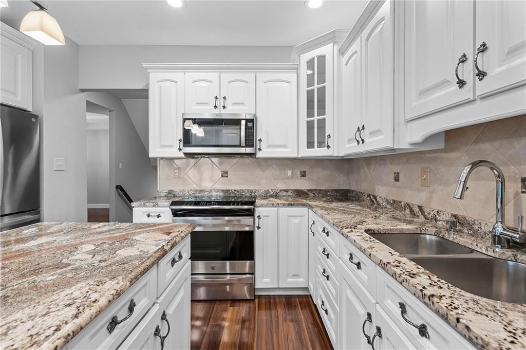 110 Aspen Lane Seven Fields, PA 16046 - Photo 17 of 50 a kitchen with stainless steel appliances granite countertop a stove a sink dishwasher and a refrigerator with wooden cabinets