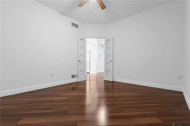 a view of an empty room and wooden floor