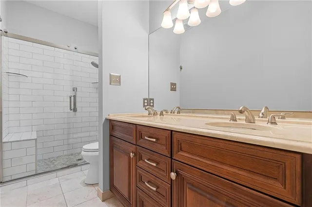 a bathroom with a double vanity sink and a toilet