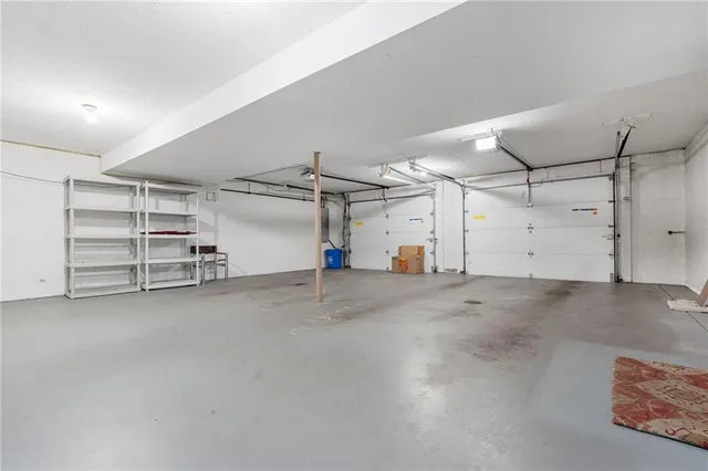 an aerial view of a house with a garden and lake view