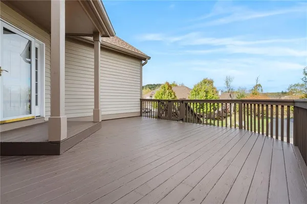 a view of a balcony with wooden floor and fence