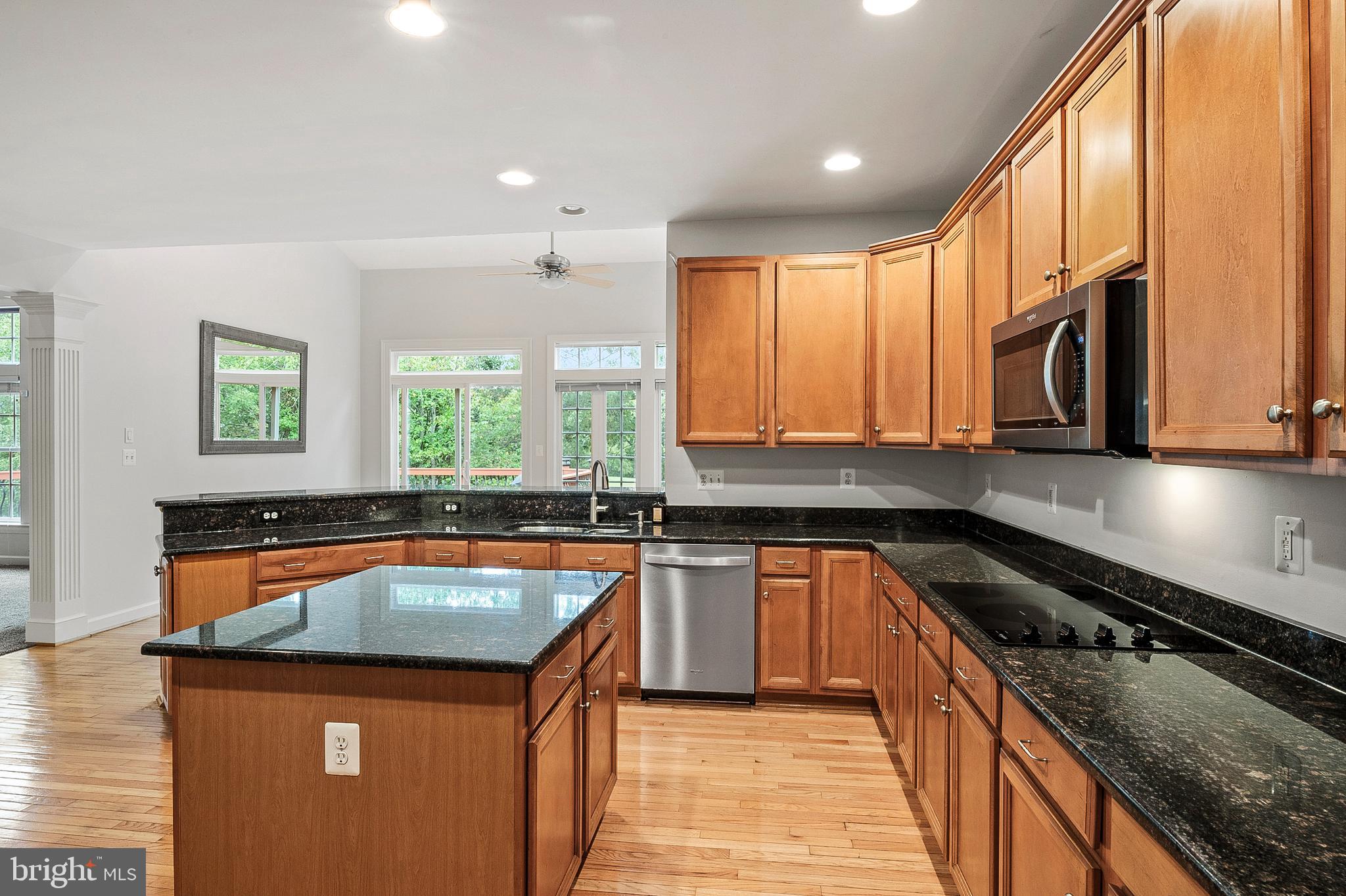 12912 Bay Hill Drive Beltsville, MD 20705 - Photo 16 of 60 a kitchen with stainless steel appliances granite countertop a sink stove and cabinets