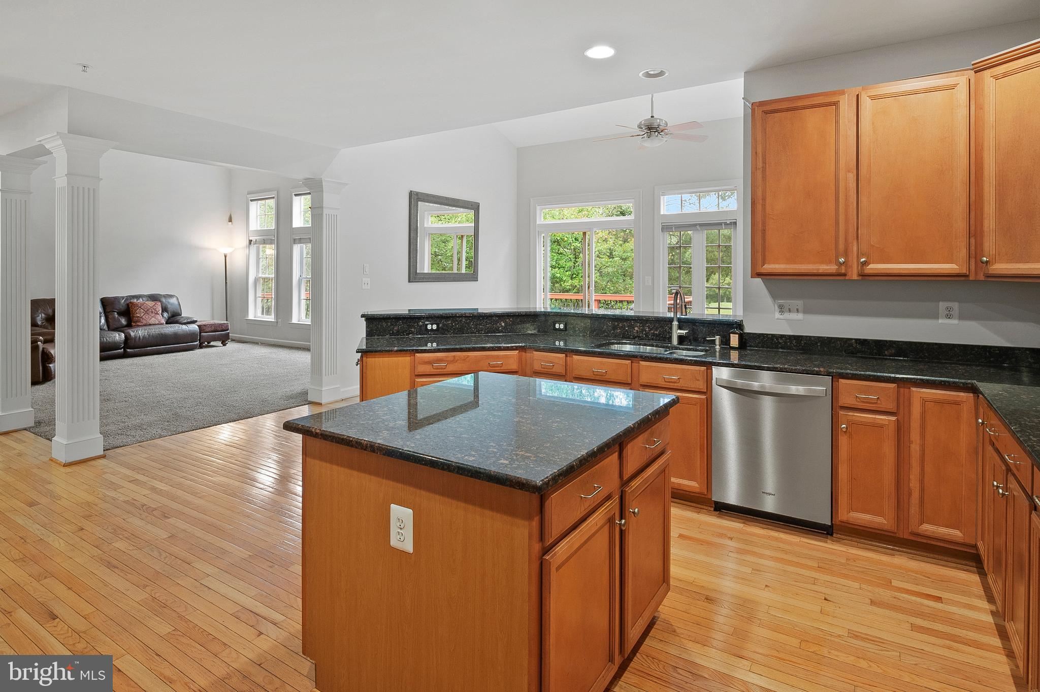 12912 Bay Hill Drive Beltsville, MD 20705 - Photo 17 of 60 a kitchen with stainless steel appliances granite countertop a sink a stove and a wooden floors