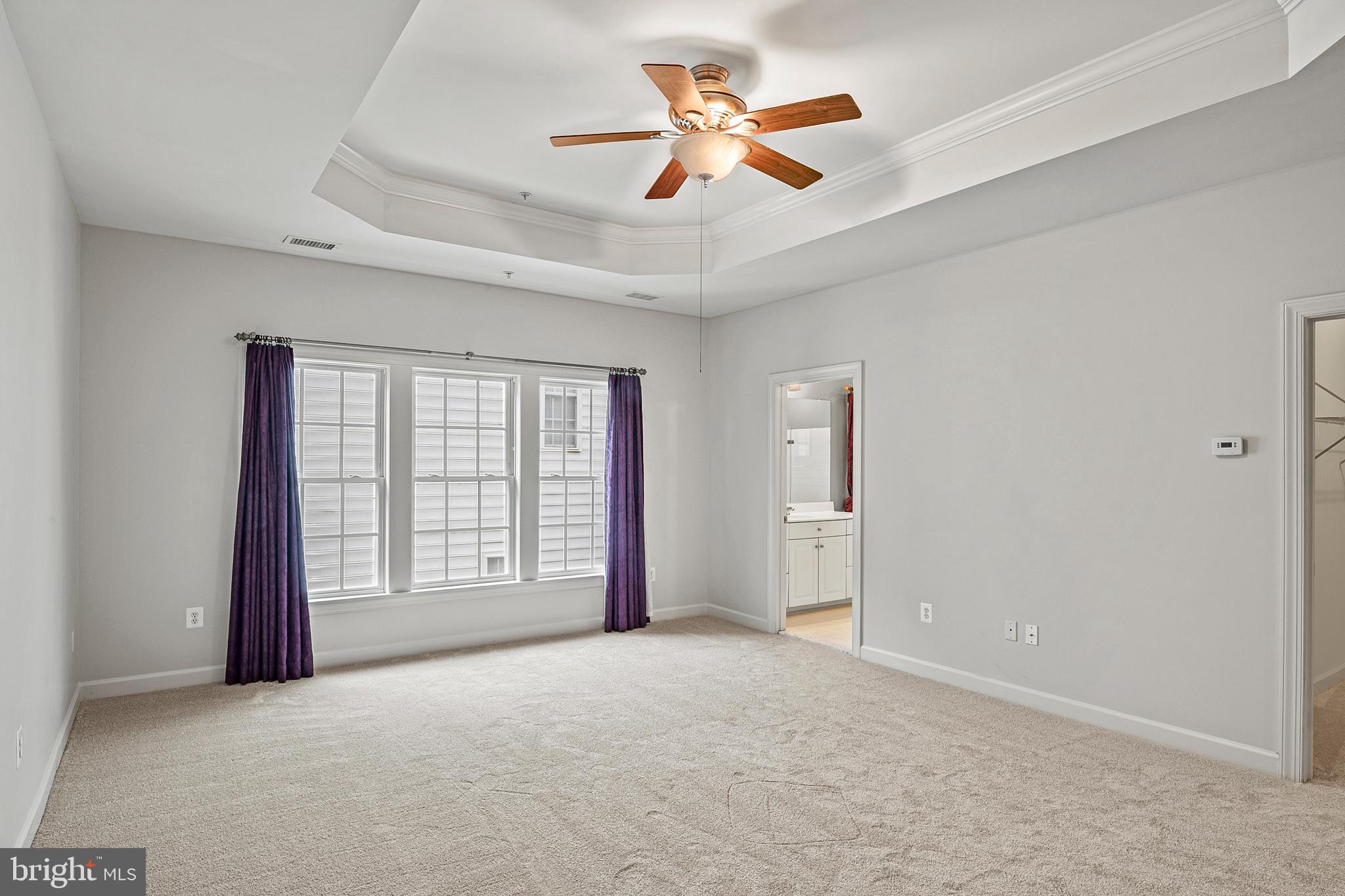 12912 Bay Hill Drive Beltsville, MD 20705 - Photo 30 of 60 an empty room with chandelier fan and windows