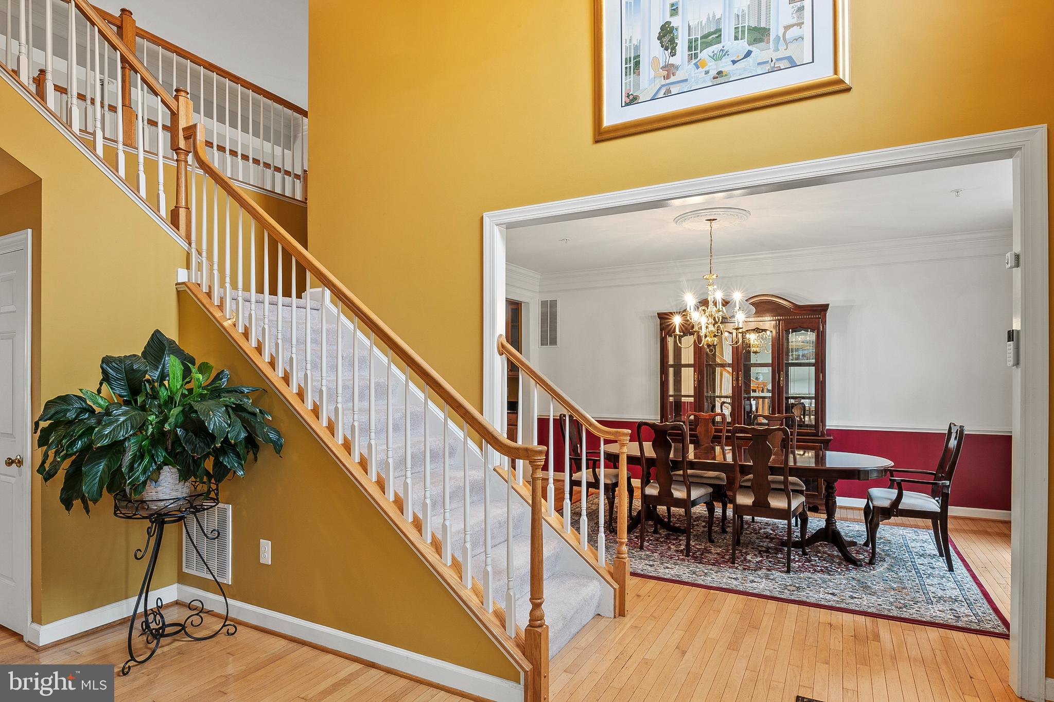 12912 Bay Hill Drive Beltsville, MD 20705 - Photo 6 of 60 a dining room with furniture a potted plant and wooden floor