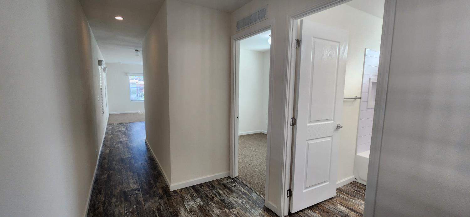 350 Pleasant Valley Road, Unit 56 Diamond Springs, CA 95619 - Photo 12 of 15 a view of a hallway with wooden floor