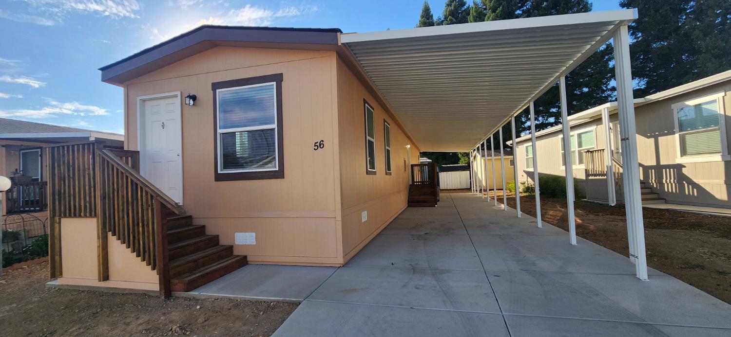 350 Pleasant Valley Road, Unit 56 Diamond Springs, CA 95619 - Photo 15 of 15 a view of a porch with wooden walls and stairs