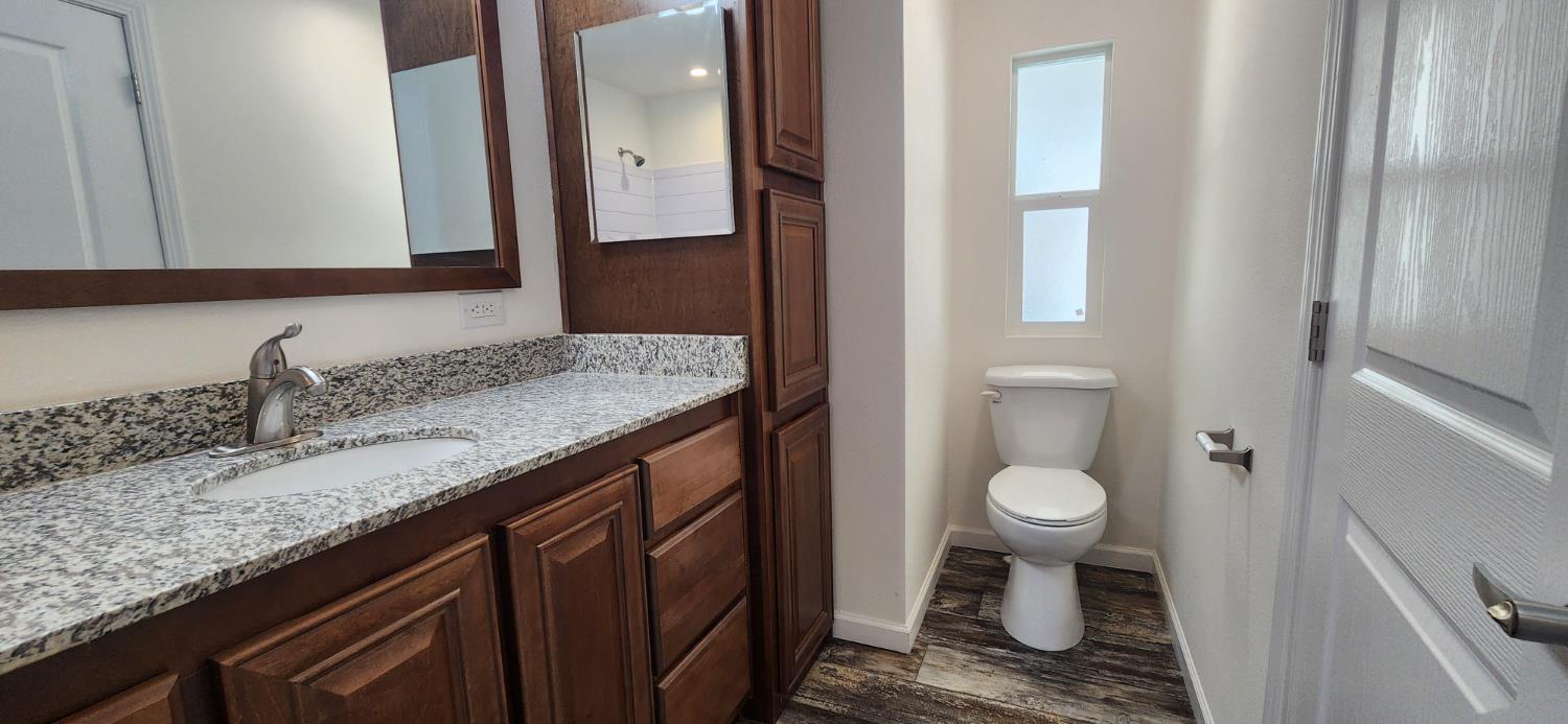 350 Pleasant Valley Road, Unit 56 Diamond Springs, CA 95619 - Photo 9 of 15 a bathroom with a double vanity sink and a mirror
