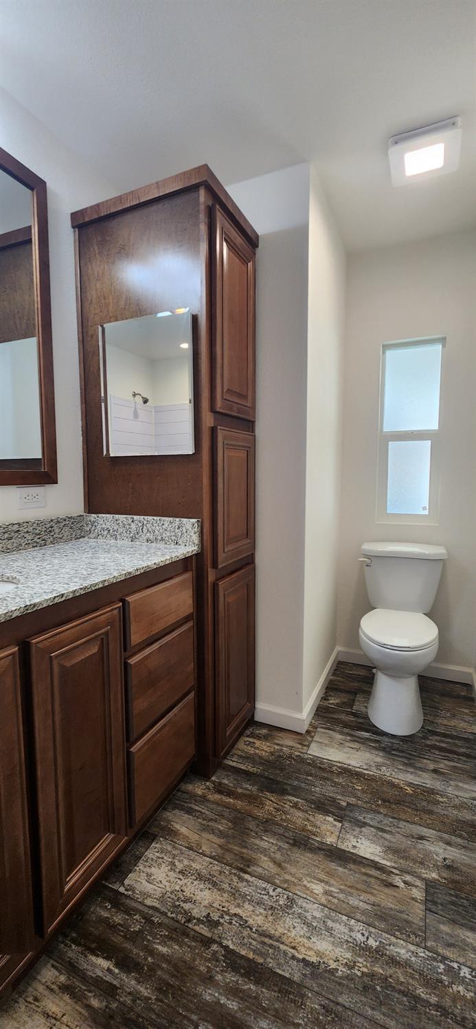 350 Pleasant Valley Road, Unit 56 Diamond Springs, CA 95619 - Photo 10 of 15 a bathroom with a granite countertop sink and a mirror
