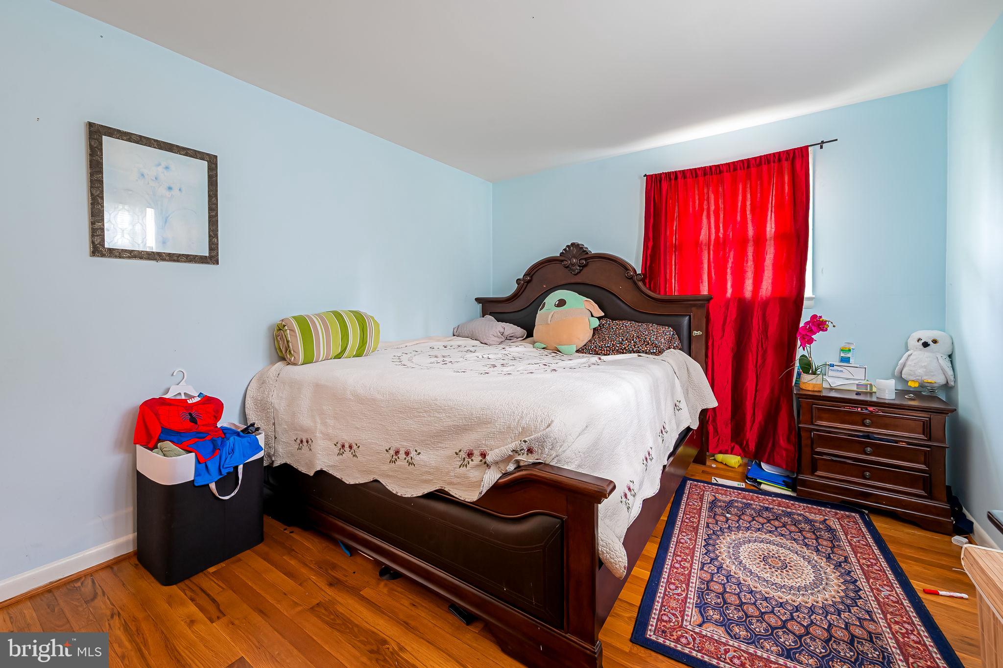 1202 Dunoon Court Silver Spring, MD 20903 - Photo 16 of 23 a bed sitting in a bedroom next to a window