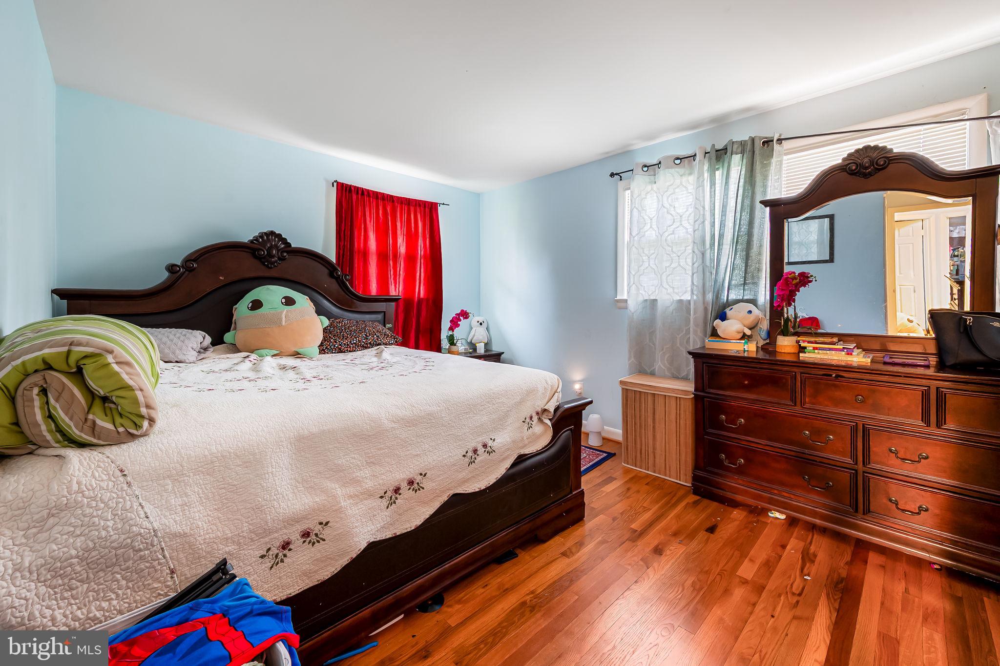 1202 Dunoon Court Silver Spring, MD 20903 - Photo 17 of 23 a bedroom with a bed and a dresser in it
