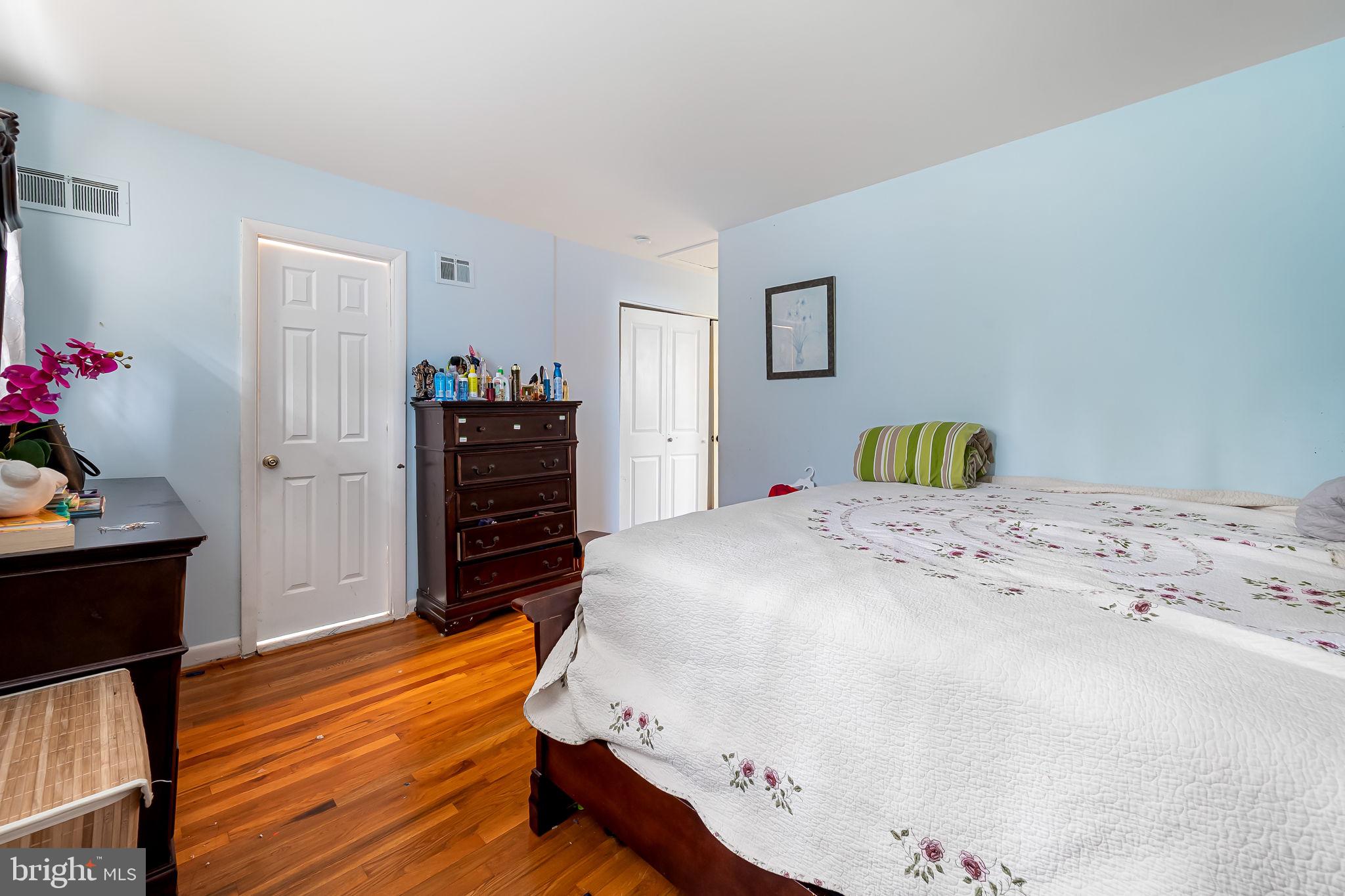 1202 Dunoon Court Silver Spring, MD 20903 - Photo 18 of 23 a bedroom with a bed and wooden floor