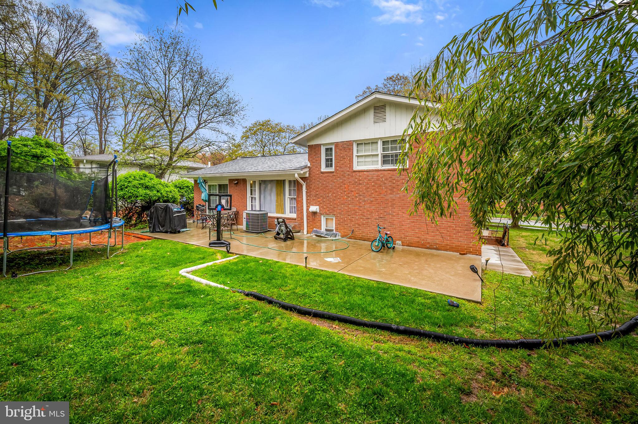 1202 Dunoon Court Silver Spring, MD 20903 - Photo 21 of 23 a view of a backyard with table and chairs and potted plants