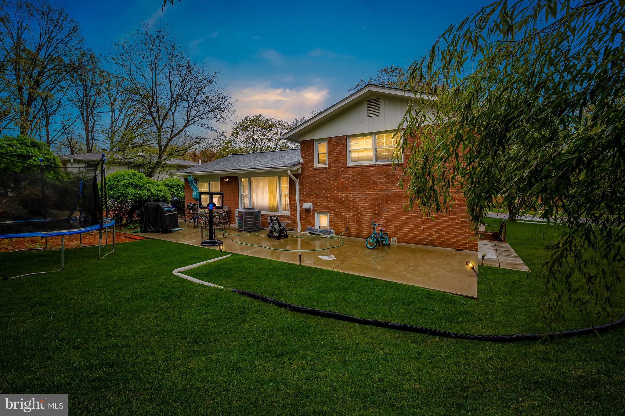 1202 Dunoon Court Silver Spring, MD 20903 - Photo 5 of 23 a front view of a house with a yard porch and outdoor seating