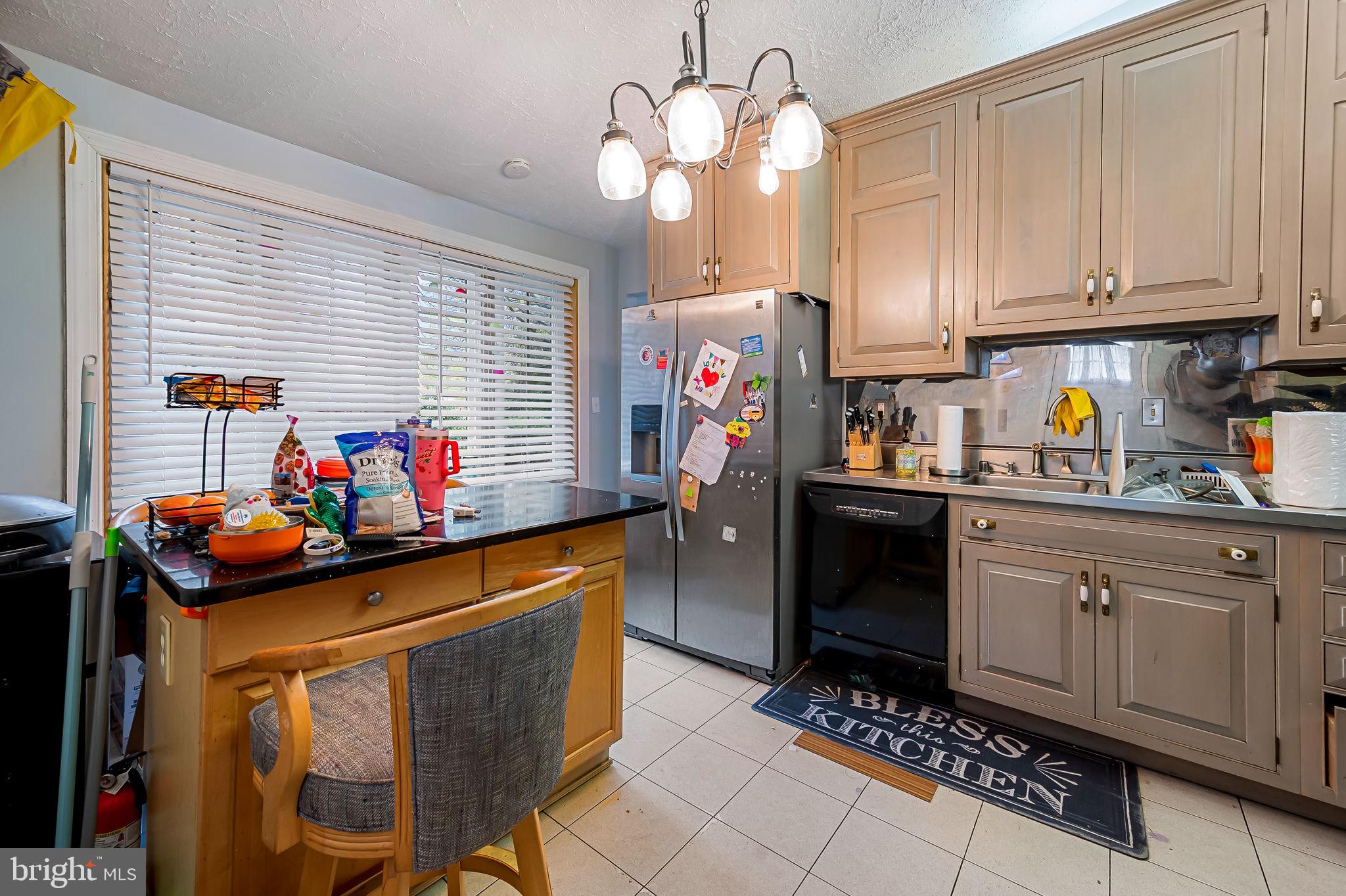 1202 Dunoon Court Silver Spring, MD 20903 - Photo 8 of 23 a kitchen with stainless steel appliances a sink a stove a refrigerator and cabinets
