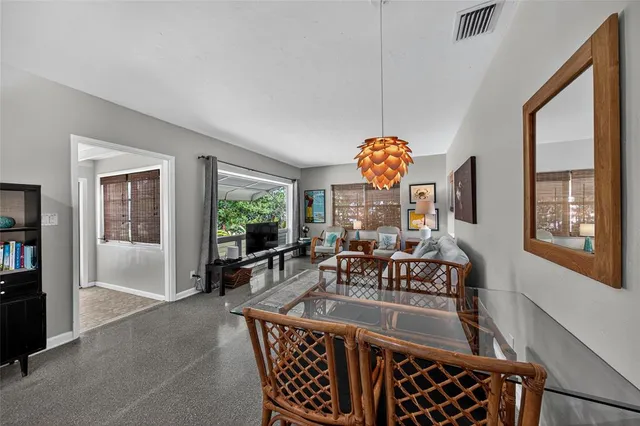 a dining room with furniture a chandelier and window