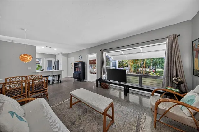 a living room with furniture a rug and a large window