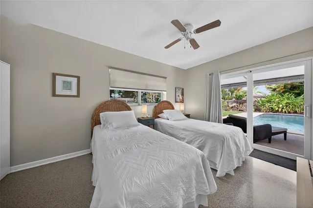 a bedroom with two large bed and a large window