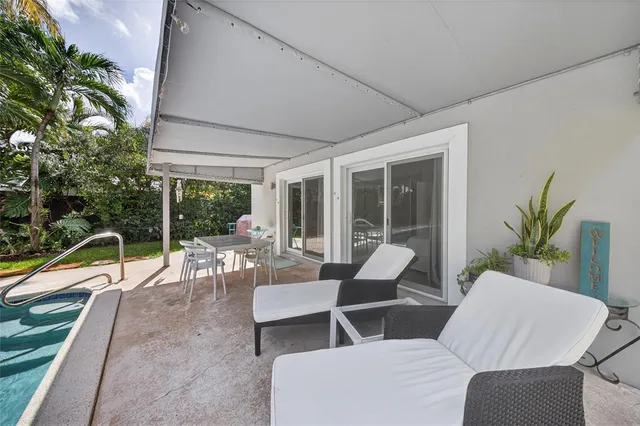 a view of a patio with couches chairs and potted plants
