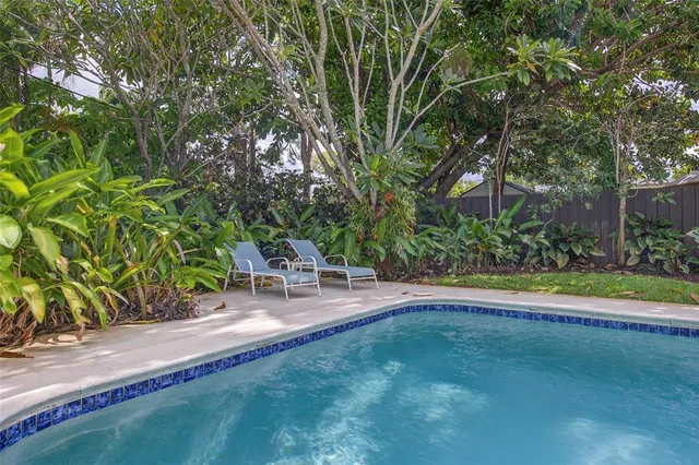 a view of a backyard with sitting area