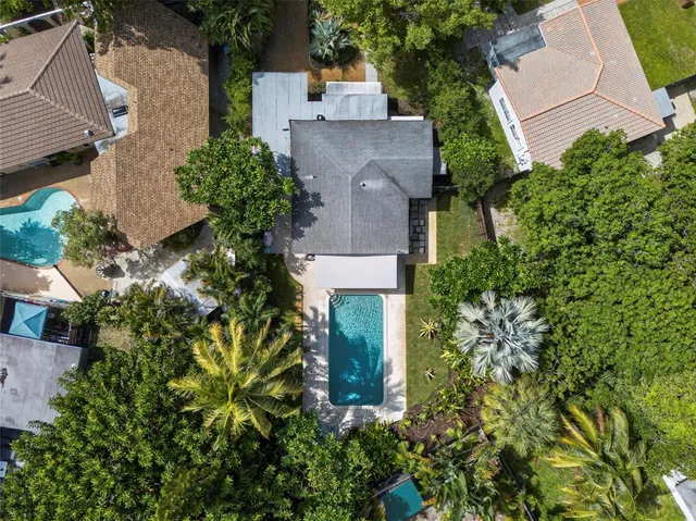 an aerial view of a house with a garden and plants