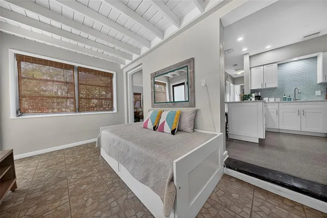 a room with a bed and a large window