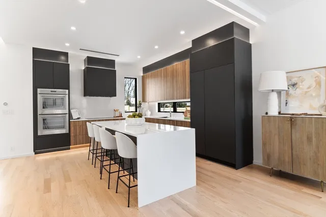 a kitchen with stainless steel appliances kitchen island granite countertop a refrigerator and a stove top oven