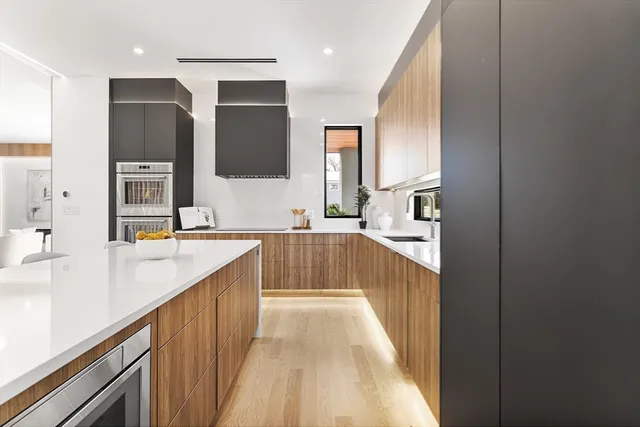 a view of a kitchen with kitchen island granite countertop a sink and dishwasher with a large window