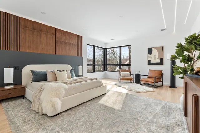 a bedroom with bed and a large window