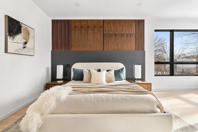 a bedroom with a large bed and a window