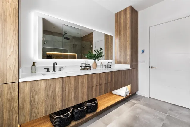a bathroom with a double vanity sink and mirror