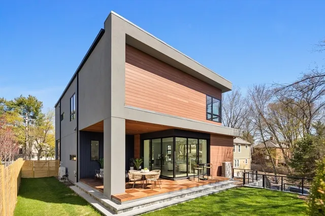 a view of a house with backyard porch and sitting area