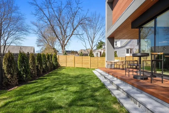 a view of a yard with plants and trees