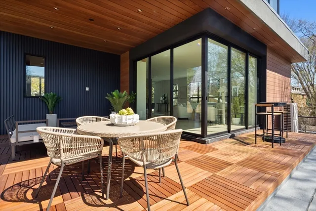 a view of a patio with a table chairs and wooden floor
