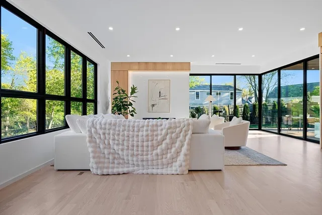 a living room with large windows and furniture