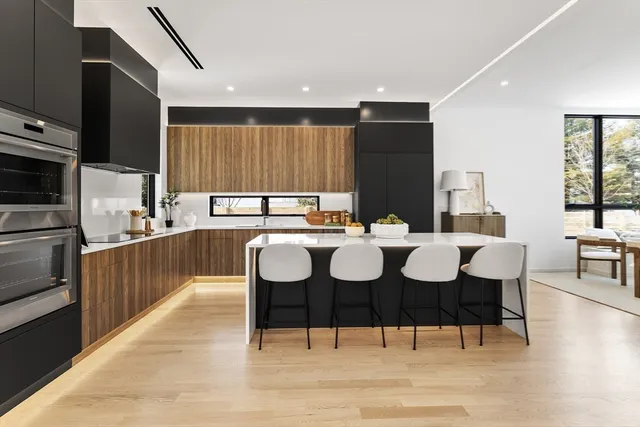 a kitchen with a sink and chairs