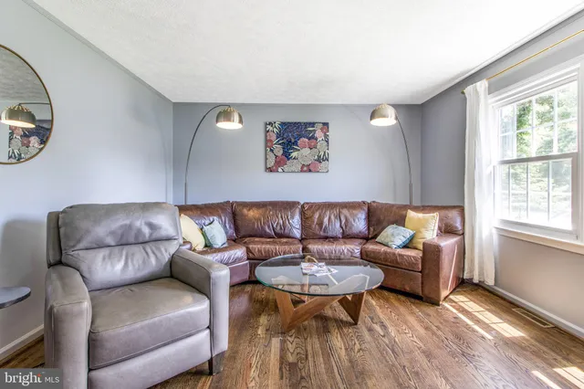 a very nice looking dining room with a couch and chandelier