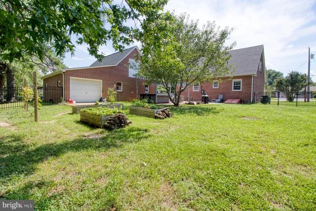 a view of a chair and table in backyard of the house
