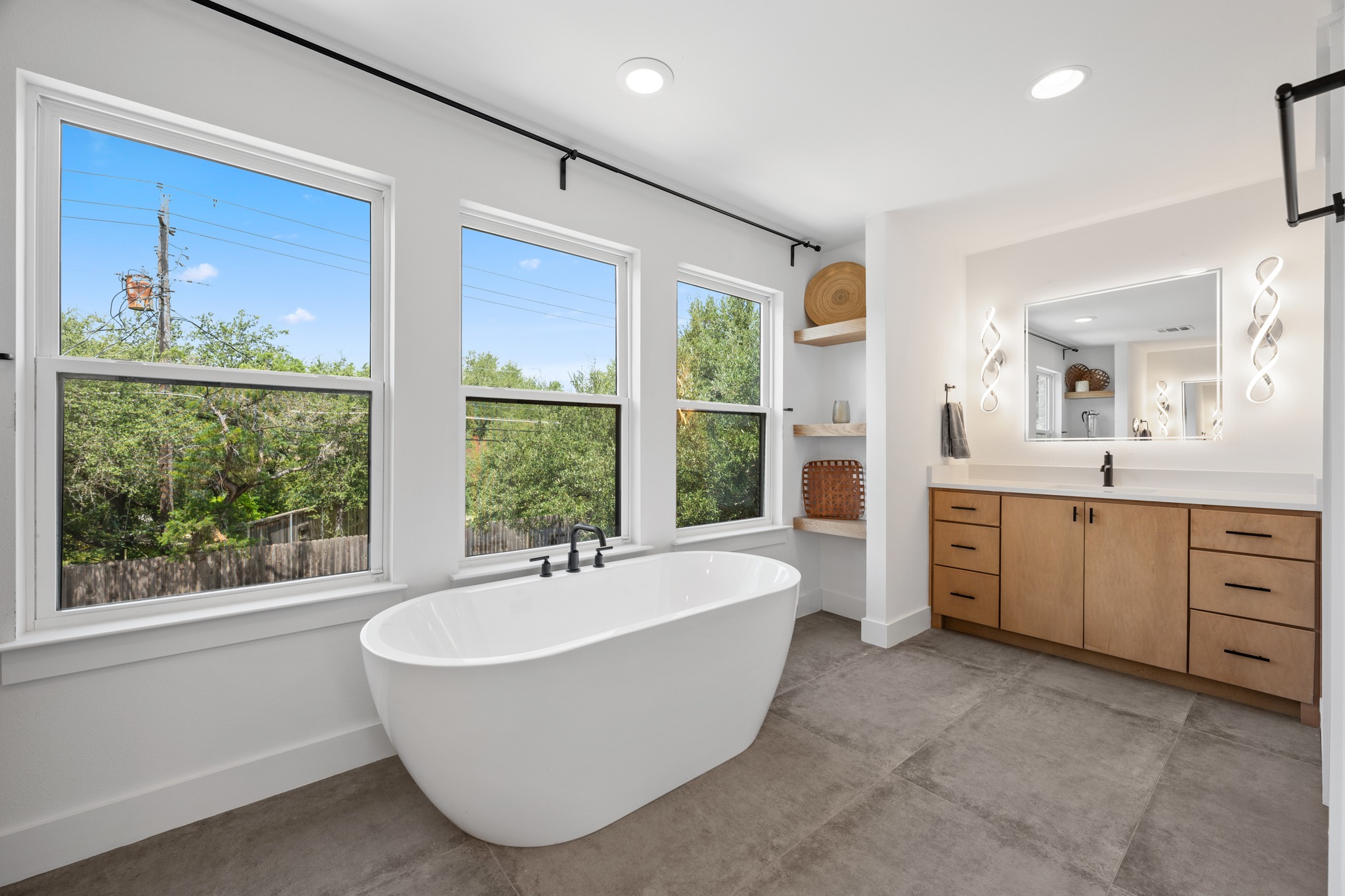 11506 Autumn Ridge Drive Austin, TX 78759 - Photo 10 of 23 Indulge in a tranquil retreat with a freestanding tub and ample vanity space in this well-appointed bathroom.