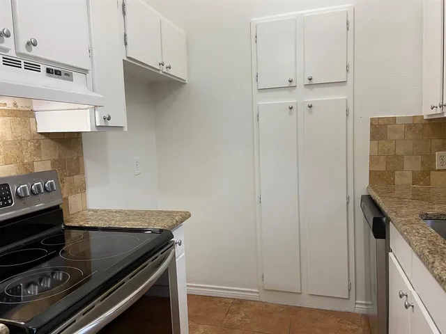 a stove top oven sitting inside of a kitchen